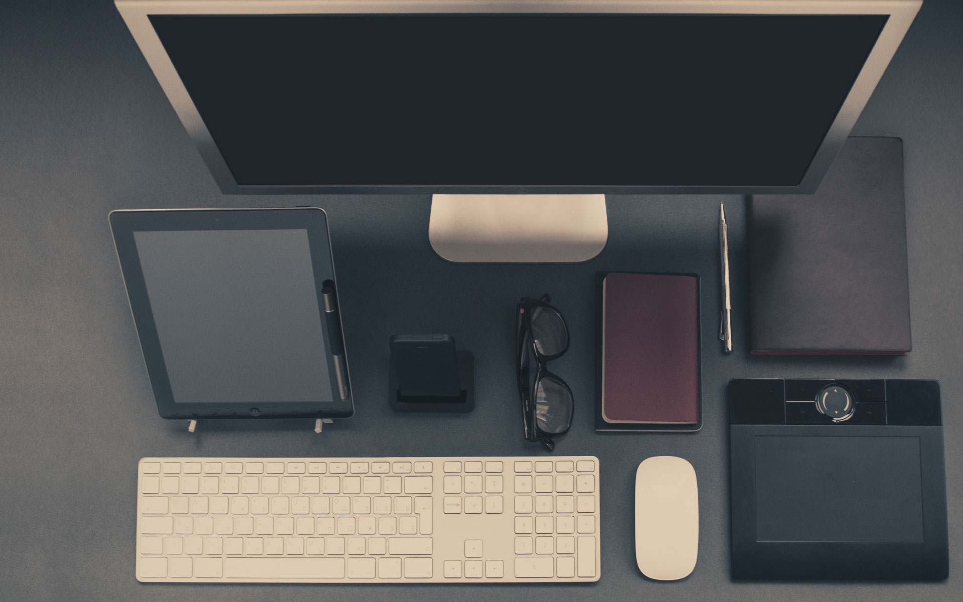 Top-down view of a software development workspace with laptop, code editor, and notes